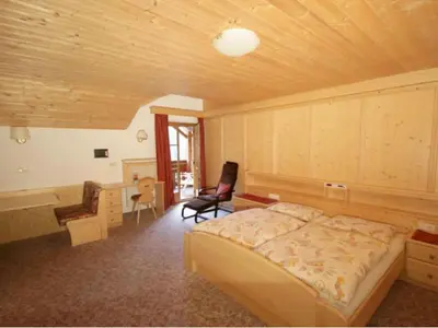 a bedroom with a bed and a desk and a chair at Haus Trögl in Tires