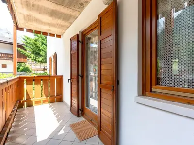 a house with wooden doors and a balcony at Apartment Ca' di nonón by Interhome in Penia