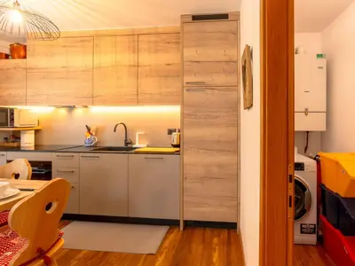 a kitchen with wooden cabinets and a sink at Apartment Ca' di nonón by Interhome in Penia