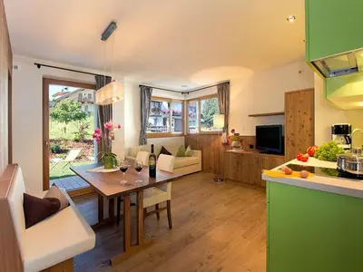 a bathroom with a sink and a toilet and a glass shower at Apartments Cornelia in Castelrotto