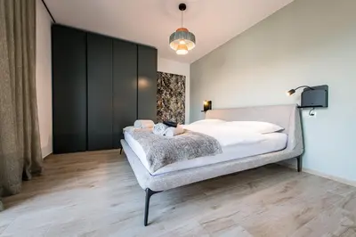 a bedroom with a bed and a tv on a wall at ANDERS City Loft in Brunico
