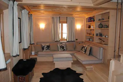 a living room with a couch and a window at Villa Zubiana in Cortina dʼAmpezzo
