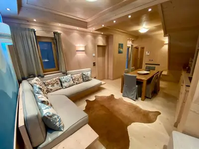 a living room with a couch and a table at Villa Zubiana in Cortina dʼAmpezzo