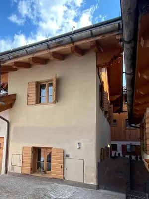 a house with wooden shutters on the side of it at Villa Zubiana in Cortina dʼAmpezzo
