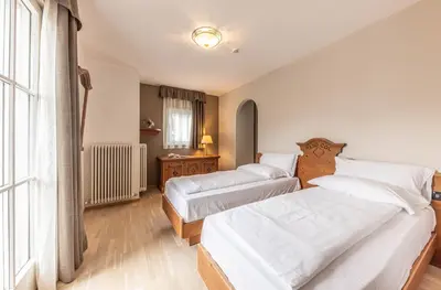a bedroom with two beds and a window at WHITE MOSS GARNì in Transacqua