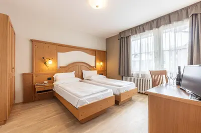 a hotel room with two beds and a television at WHITE MOSS GARNì in Transacqua