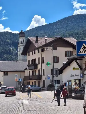 a group of people walking down a street near a building at Appartamento Medán in Mezzano