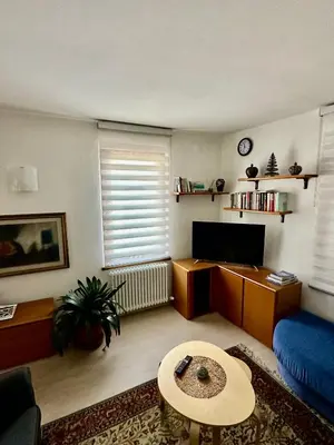 a living room with a blue couch and a table at Appartamento Medán in Mezzano