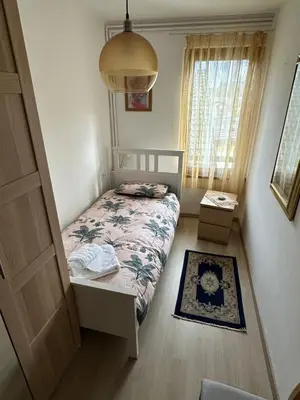a small bedroom with a bed and a window at Appartamento Medán in Mezzano