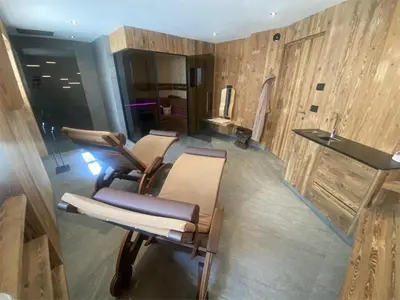 a spa room with two chairs and a sink at Romys Apartment in Selva di Val Gardena