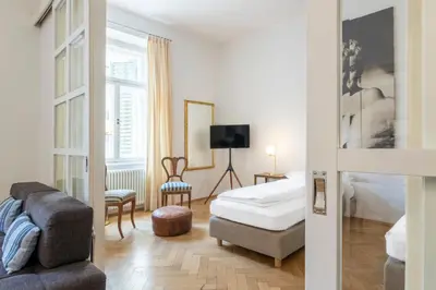 a hotel room with a bed and a chair at Stay COOPER l Laurenz in Bolzano