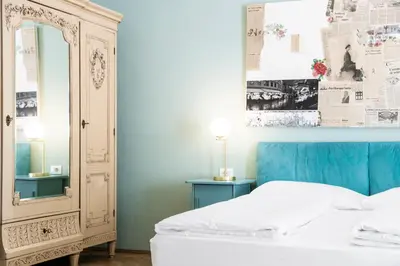 a bedroom with a white bed and a mirror at Stay COOPER l Laurenz in Bolzano