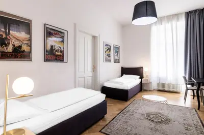 a small room with two beds and a table at Stay COOPER l Laurenz in Bolzano
