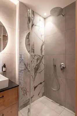 a bathroom with a shower with a glass door at Le Fronde - Naturally Smart in Cles