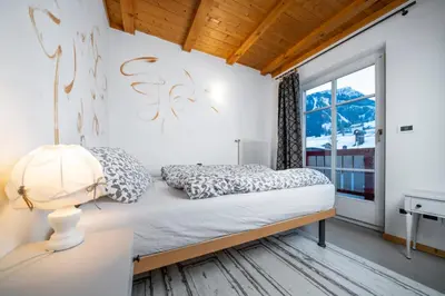 a bedroom with a bed and a window at Ciasa Buro - Resh in Moena