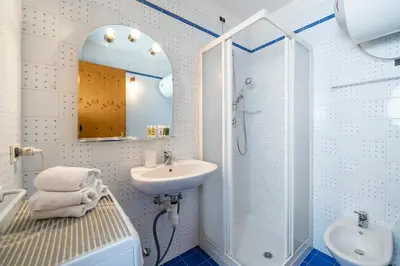 a white bathroom with a sink and a shower at Ciasa Buro - Resh in Moena