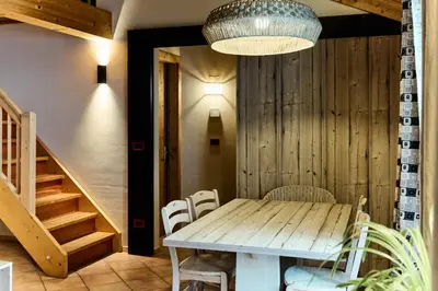 a dining room with a wooden table and chairs at Ciasa Buro - Resh in Moena