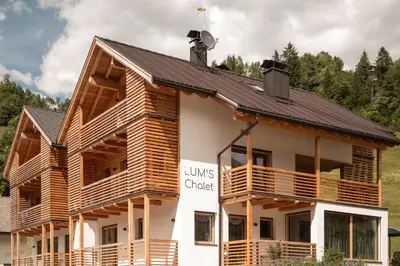 a log cabin with a black roof at Chalet Lumis in San Vigilio Di Marebbe