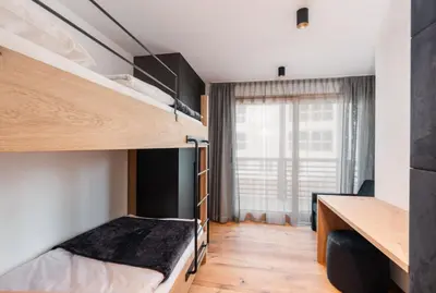 a bedroom with two bunk beds and a desk at Chalet Lumis in San Vigilio Di Marebbe