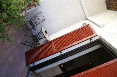 an overhead view of a red bench on a building at Garni Villa Betty in Merano