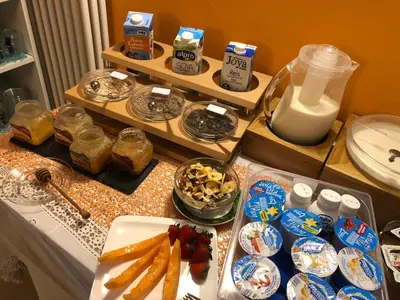 a table with a bunch of food on it at Garni Villa Betty in Merano