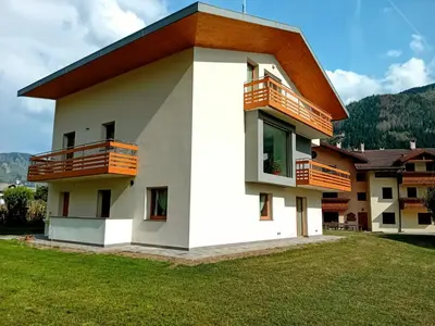 a house with balconies on the side of it at Appartamento Miele di Pino in Ziano di Fiemme