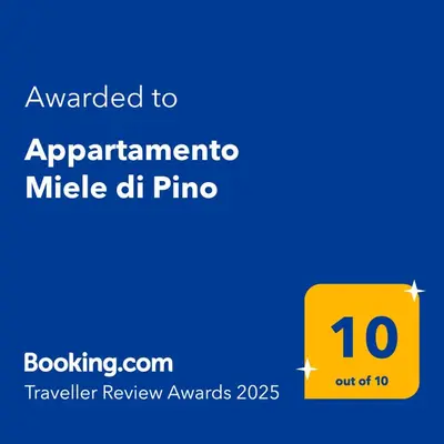 a yellow sign with the text awarded to appartmentmetric mile dh piano at Appartamento Miele di Pino in Ziano di Fiemme