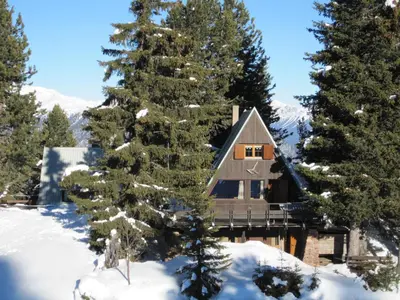 a log cabin in the snow with trees at Chalet Cermis in Cavalese