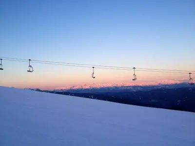 a ski lift on top of a snow covered slope at Chalet Cermis in Cavalese