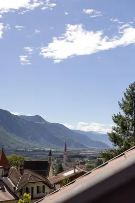 a view of a town with mountains in the background at Stöckler Hof in Lana