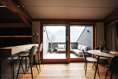 a room with a table and chairs and a patio at Stöckler Hof in Lana