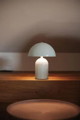 a white lamp sitting on top of a wooden shelf at Stöckler Hof in Lana