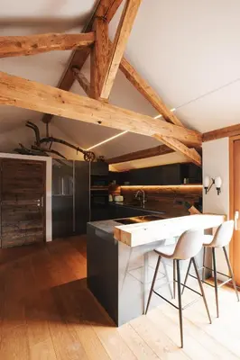 a kitchen with a white counter and wooden ceilings at Stöckler Hof in Lana