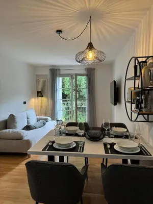 a living room with a table with chairs and a couch at Öhlers Prime Suite in Vipiteno