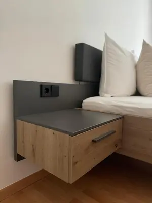 a bed room with a table next to a bed at Öhlers Prime Suite in Vipiteno