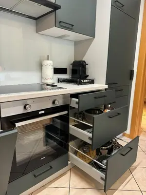 a kitchen with a counter with glass drawers at Öhlers Prime Suite in Vipiteno