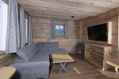 a living room with a couch and a flat screen tv at Chalet Roderer in Laion