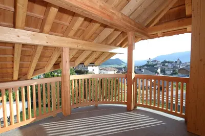 a wooden deck with a roof with a view at Chalet Roderer in Laion