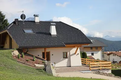 a small white house with a black roof at Chalet Roderer in Laion
