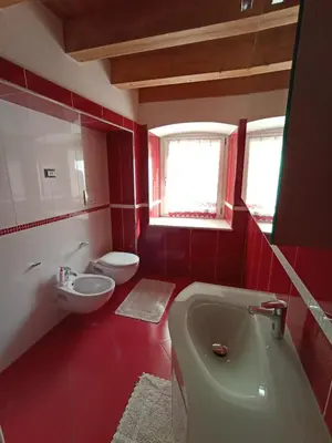 a bathroom with a tub and a toilet and a sink at Appartamento Lorena a Mezzano in Mezzano