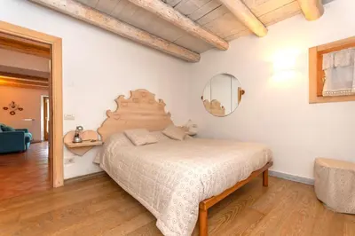 a bedroom with a bed and a mirror at Casa Alessandra in Falcade
