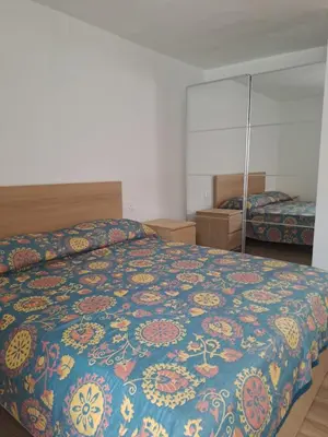a bedroom with a bed with a colorful blanket at Casa Dolomiti in Mezzano
