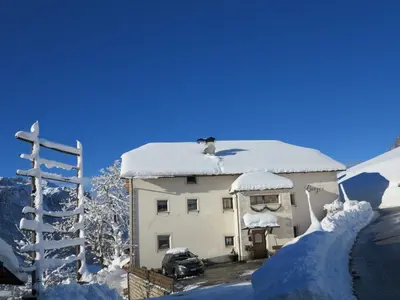 a building with snow on the top of it at Larjëi in San Cassiano