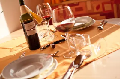 a bottle of wine sitting on a table with glasses at Platterhof in Avelengo