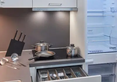 a kitchen with two pots and pans on a stove at Ferrari Tower in Bolzano