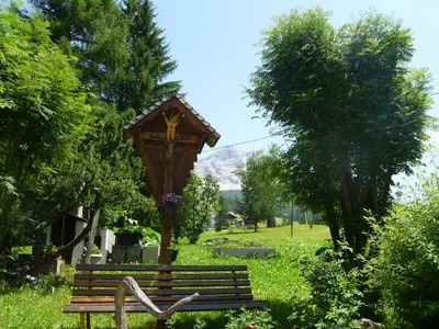 two girls sitting on a swing in a yard at Elmes in La Villa