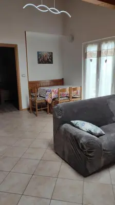a living room with a couch and a table at Appartamento vacanza Coredo Trentino in Coredo
