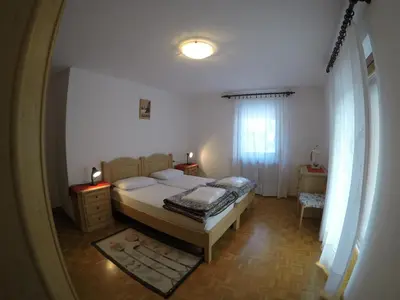 a small bedroom with a bed and a window at Majon Di Roces in Canazei