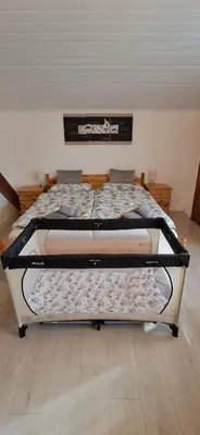 a bed in a room with a bed frame at Haus Tauber in Cornaiano