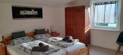 a bedroom with a bed with two pillows on it at Haus Tauber in Cornaiano